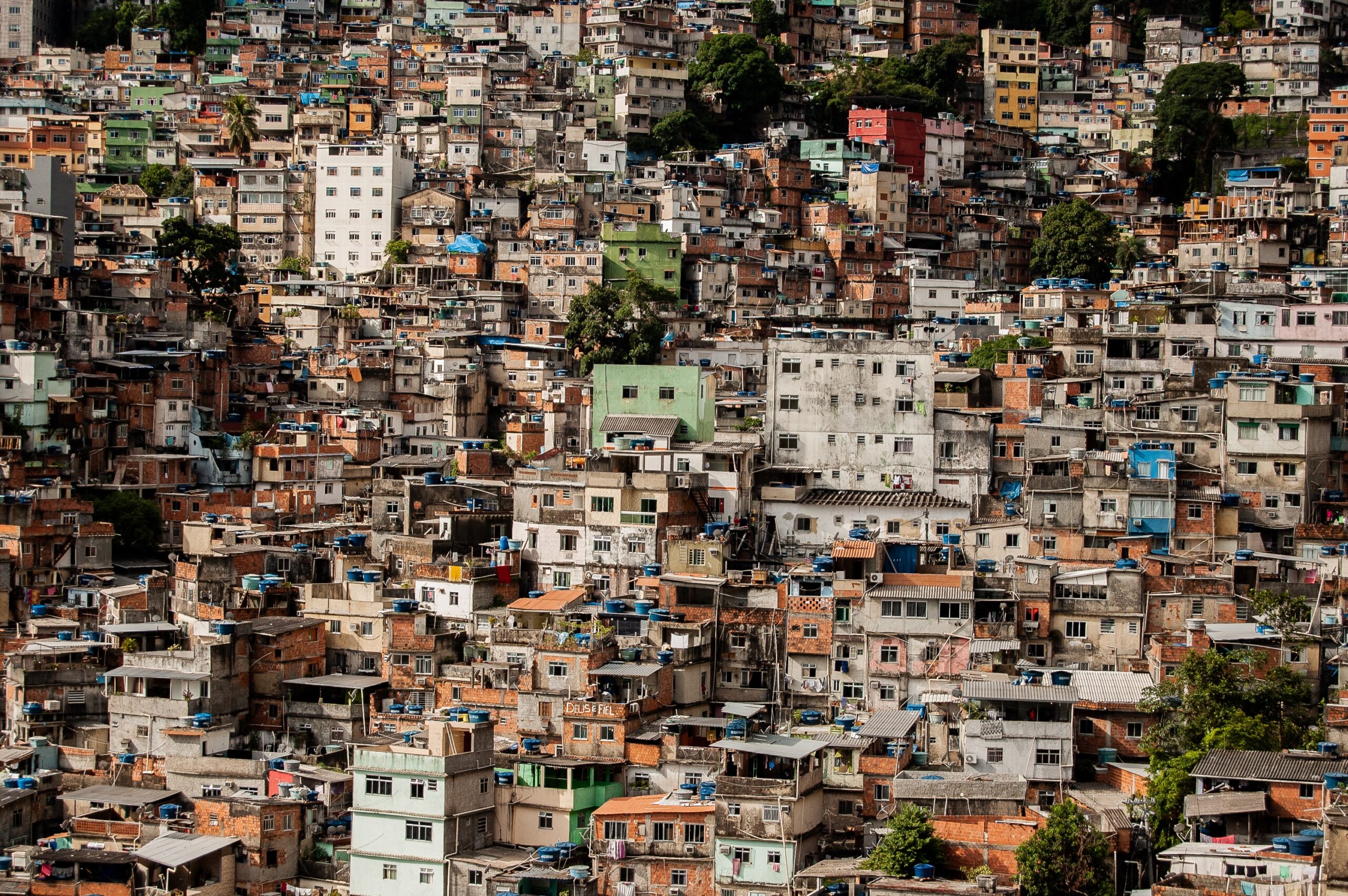 An aerial shot of small building near to each other on a hill